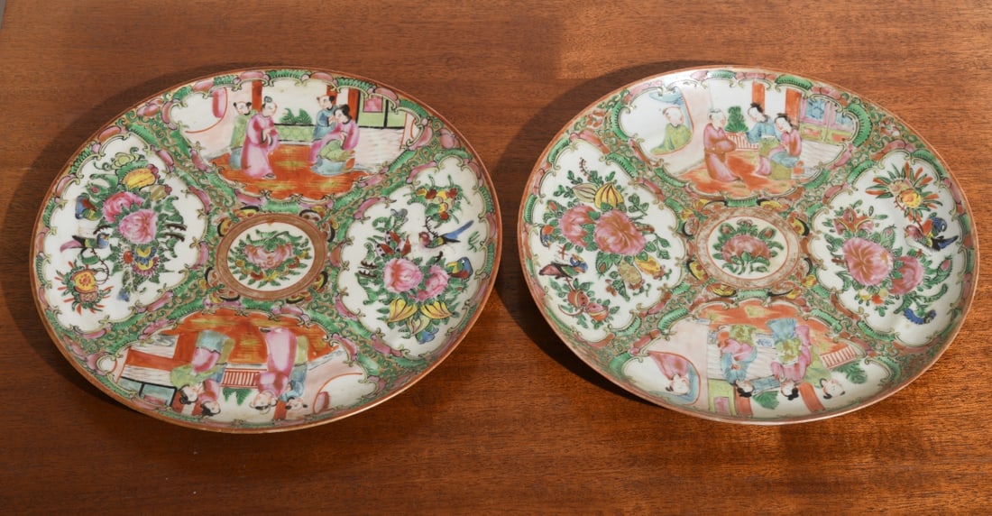 Two Chinese Export Style Rose Medallion Plates: ecorated in famille rose enamels with alternating figural courtyard scenes and floral reserves with birds and butterflies within scrolling borders. Unmarked. Likely late 19th to early 20th century.