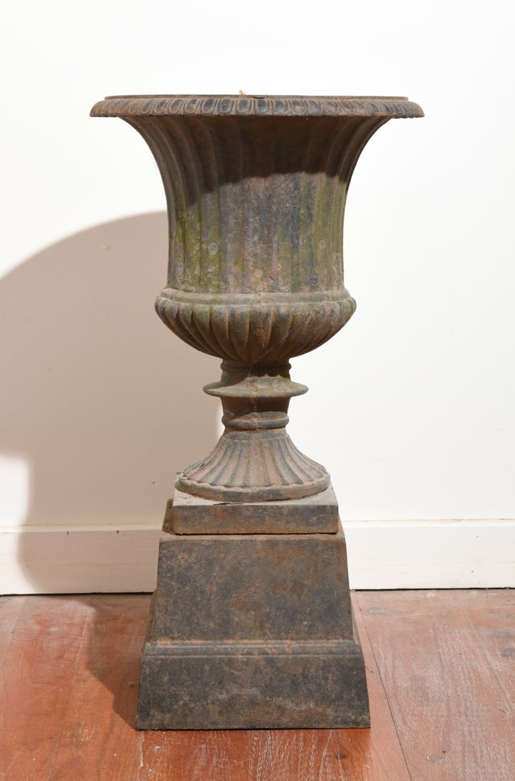 Cast Iron Garden Urn: With weathered patina and some rust. Dimensions approx. 18 1/2" H x 14 1/4" dia. Our primary recommendation is to arrange shipping yourself using Blue Ridge Pack & Ship. Most bidders find this is the 
