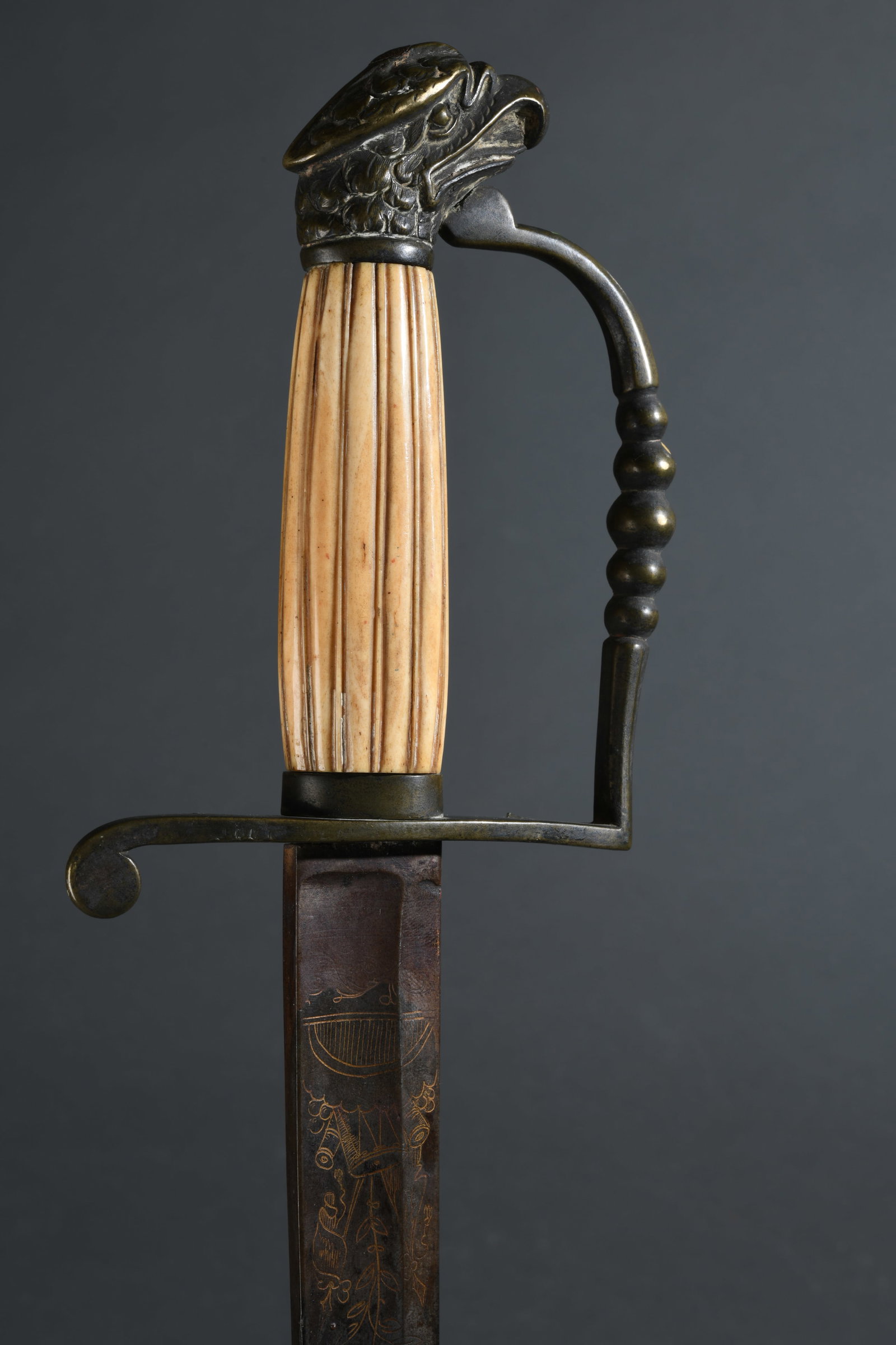 19th C. Eagle Head Sword: Eagle head hilted sword or hanger, early to mid 19th century. Straight single edged steel blade with etched and partially gilt foliate decoration and “Warranted” (partially legible) banner at 