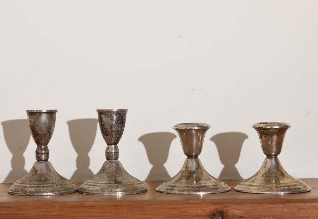 Two Pairs of Weighted Sterling Candlesticks: Marked to Gorham and Duchin Creation. Gorham: approx. 3 1/4" H x 3 3/4" Dia.Duchin Creation: approx. 4" H x 3 1/2" Dia. Our primary recommendation is to arrange shipping yourself using Blue Ridge