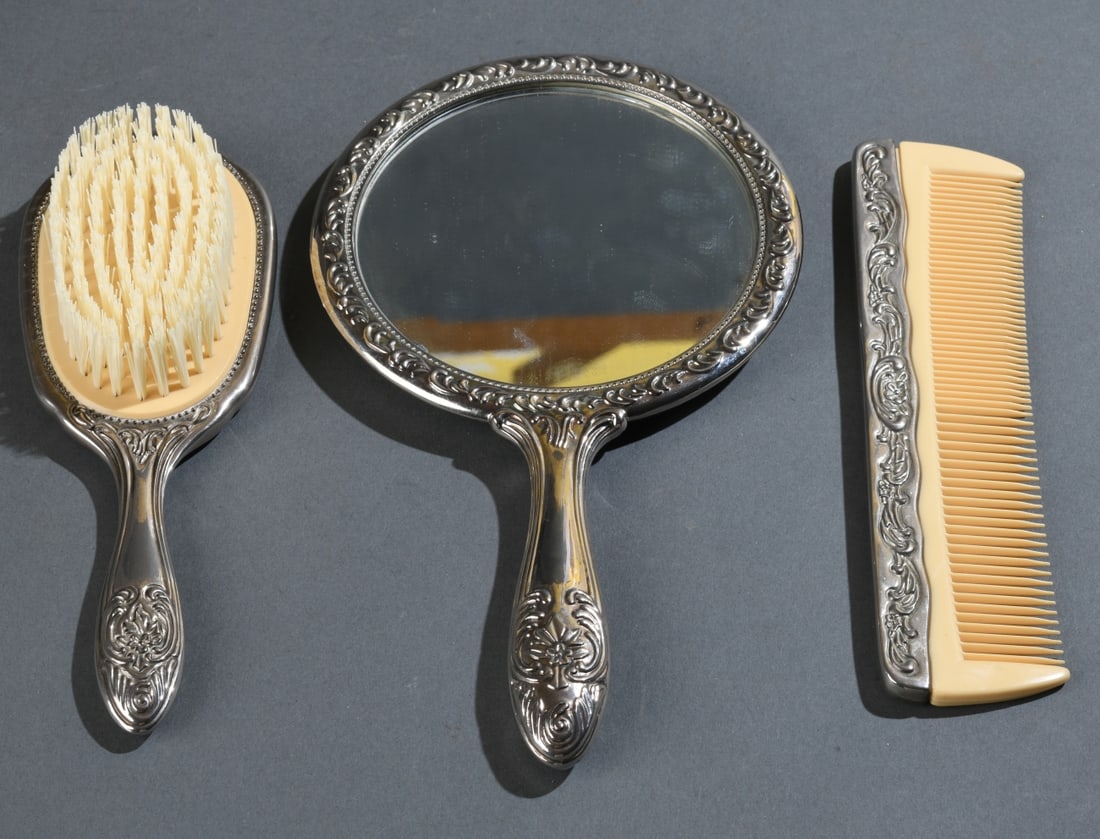 Silverplate Brush, Comb and Mirror: No monograms, no visible maker's marks. Largest (mirror): 9 1/4" x 5 1/4". Our primary recommendation is to arrange shipping yourself using Blue Ridge Pack & Ship. Most bidders find this is the most