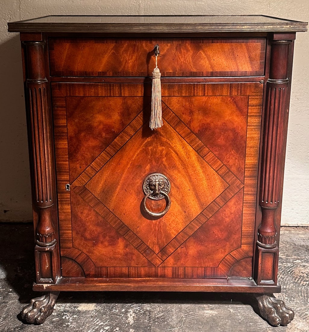 Regency Style Mahogany Cellarette Cabinet: 20th century, rectangular top with brass edge molding over single dovetailed drawer and paneled cabinet door with ringed ram's head pull opening to a fitted interior compartment, flanked by reeded qua