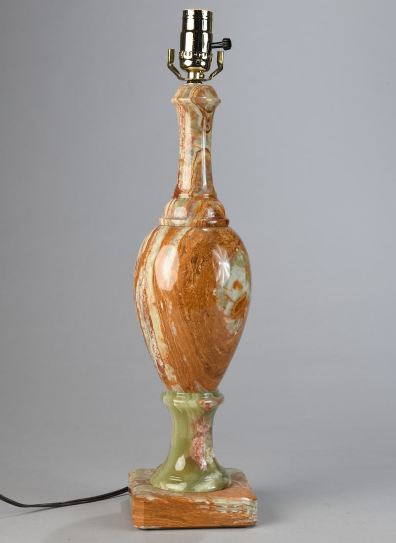 Carved Onyx Vase Form Lamp: Carved stone lamp of baluster and bottle form with variegated cream, honey, rust, and pale green veining, raised on a square plinth base. Powers on. Dimensions approx. 21 1/4" x 5" x 5". Our primary r