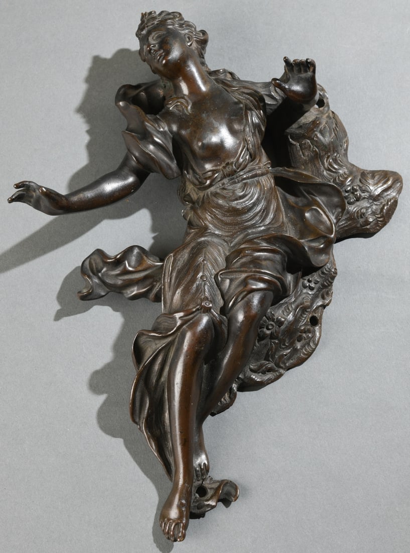 Bronze Figural Mount of a Classical Maiden: Continental School figural furniture or architectural mount, relief modeled as a reclining classical female figure with flowing drapery and outstretched arms, the reverse with mounting holes and open 