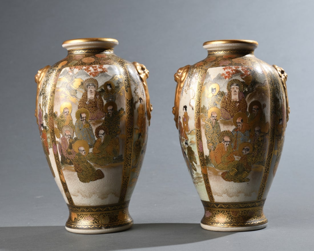 Near Pair of Japanese Satsuma: Baluster form with molded gilt lion handles, decorated in gilt and polychrome enamels with figural scenes, marked to undersides with Shimazu crest and painted character marks. Meiji period, late 19th 