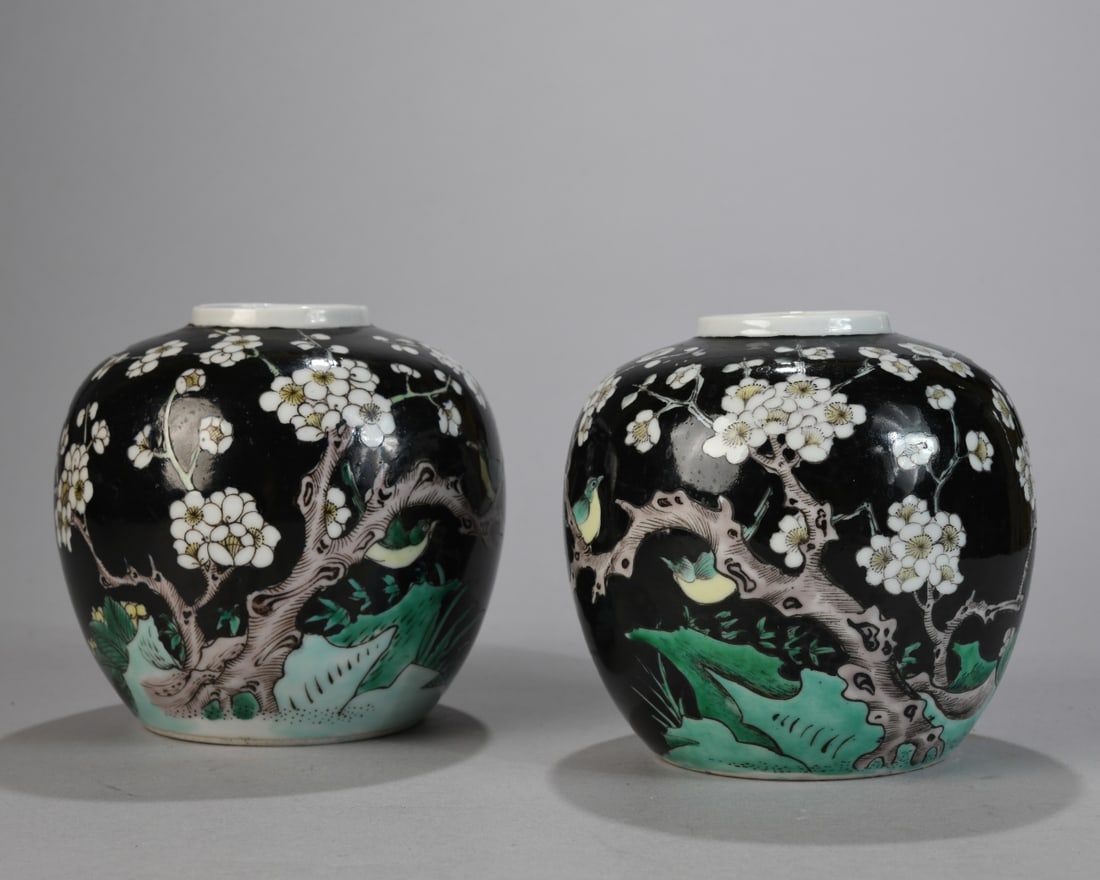 Pair of 20th C. Chinese Vases: Glazed porcelain, each of compressed globular form with short straight neck, decorated on a black ground with flowering prunus branches and small birds above green landscape elements, unmarked. Light