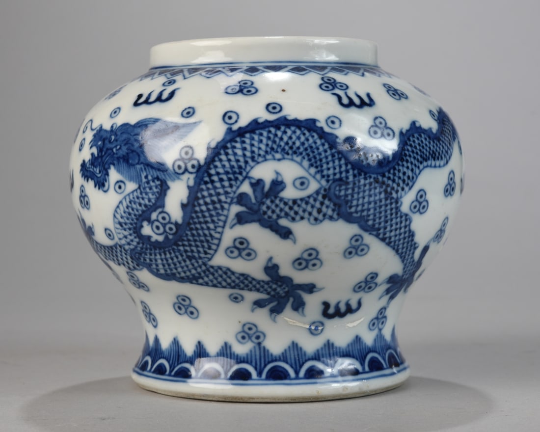 Chinese Blue and White Vase: Compressed globular form with short straight neck and footed base, decorated in underglaze cobalt with a striding dragon amid stylized clouds and flaming pearls, with geometric and wave borders; under