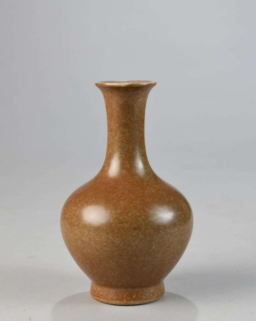 Chinese Stoneware Vase: Globular body with tall cylindrical neck and slightly flared rim, covered in a mottled brown glaze, the interior rim showing a reddish wash; the base unglazed with visible throwing rings. 20th century