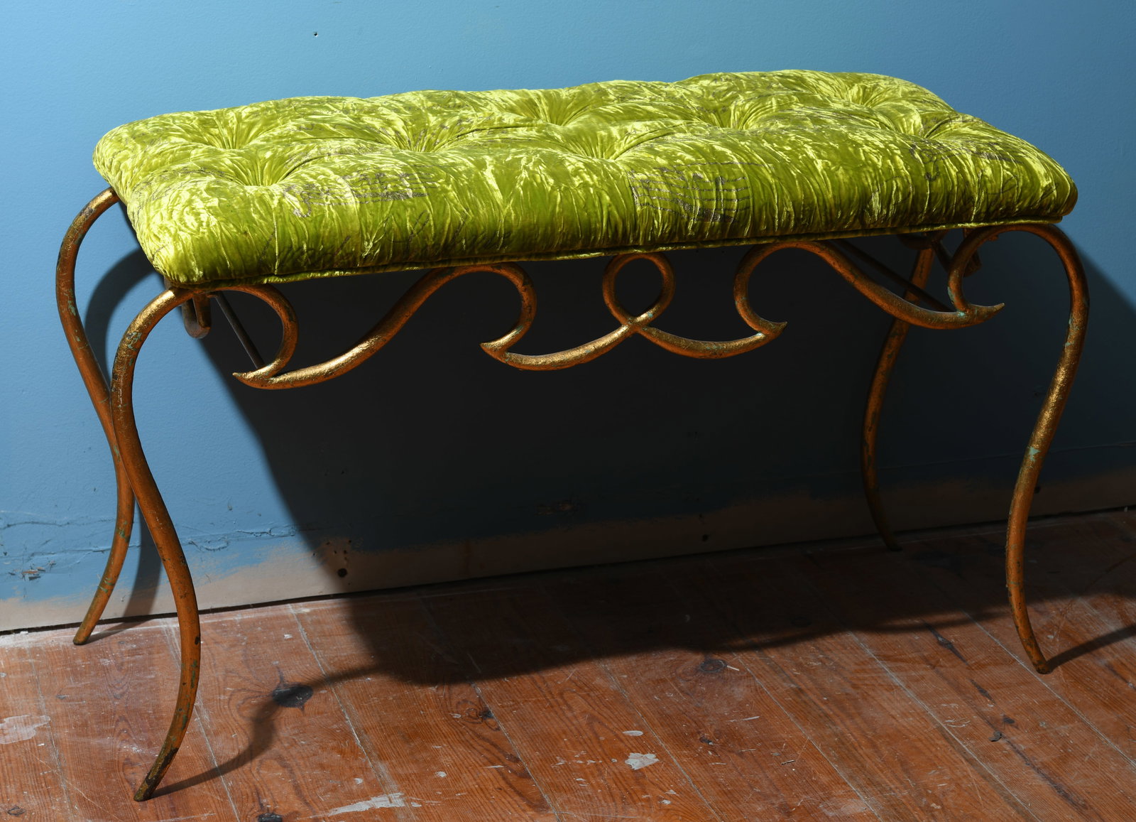 Hollywood Regency-Style Gilt Metal Bench: Upholstered rectangular seat in tufted chartreuse crushed velvet fabric with scrolling gilt metal base and cabriole-form legs, late 20th century. Upholstery with wear, fading, and scattered staining; 