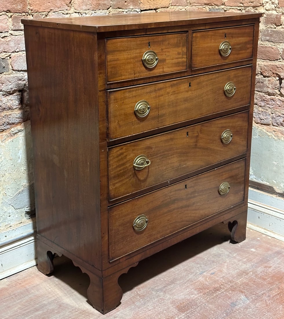 19th C. English Mahogany Veneered Chest of Drawers: Circa 1815, with sycamore and red pine secondary, rectangular top with ebony line inlay above two short dovetailed cockbeaded drawers with brass pulls and three long drawers, shaped skirt, bracket fee