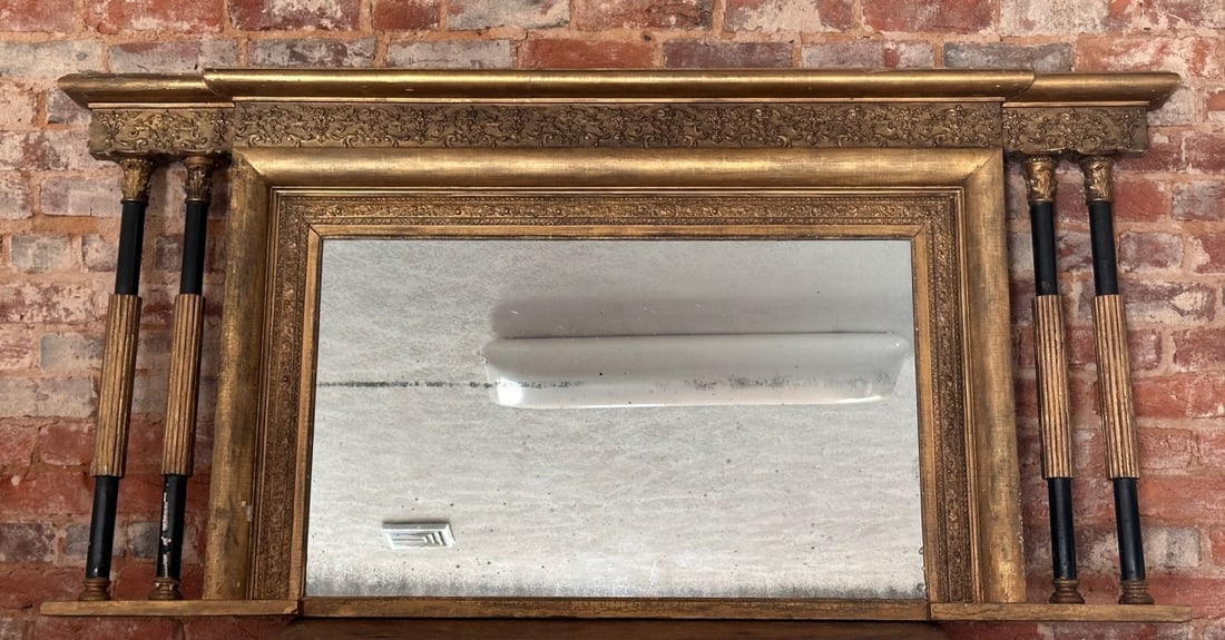 19th Century Giltwood Overmantel Mirror: Large 19th century giltwood overmantel mirror, the rectangular plate set within an ornately molded frame with foliate and scroll decoration. Overall wear consistent with age and use. Scattered losses,