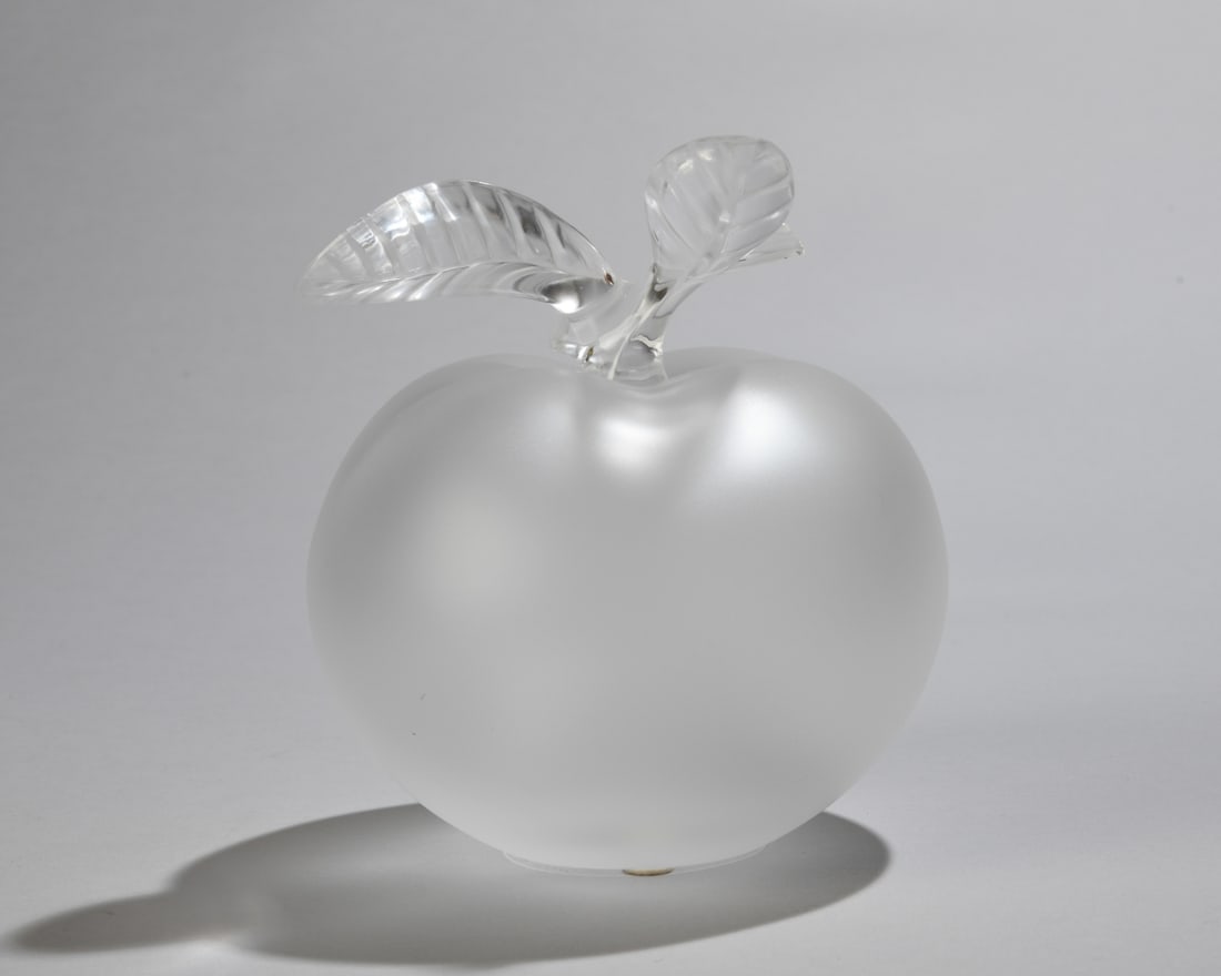 Lalique Grande Pomme Perfume Bottle and Stopper: Lalique apple-form frosted glass bottle with leaf-form stopper, 20th century. Marked to underside. No visible chips, cracks, or repairs. Dimensions approx. 5 3/4" H x 5" W. Our primary recommendation