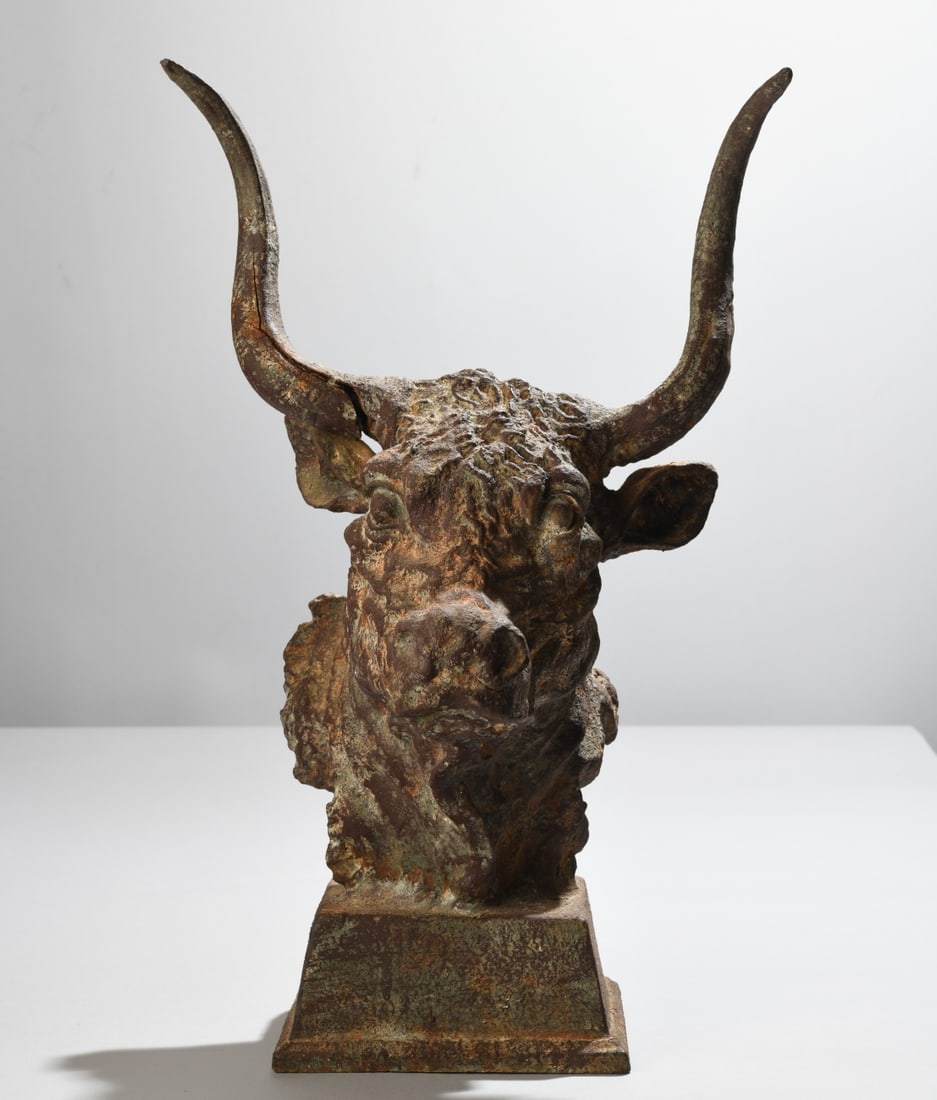 Cast Iron Bull Head Architectural Ornament: Figural architectural element, modeled as the head of a longhorn bull, unmarked, probably early 20th century, with fractures and damage, weathered patina. Dimensions approx. 20 1/2" x 12 1/2" x 9".