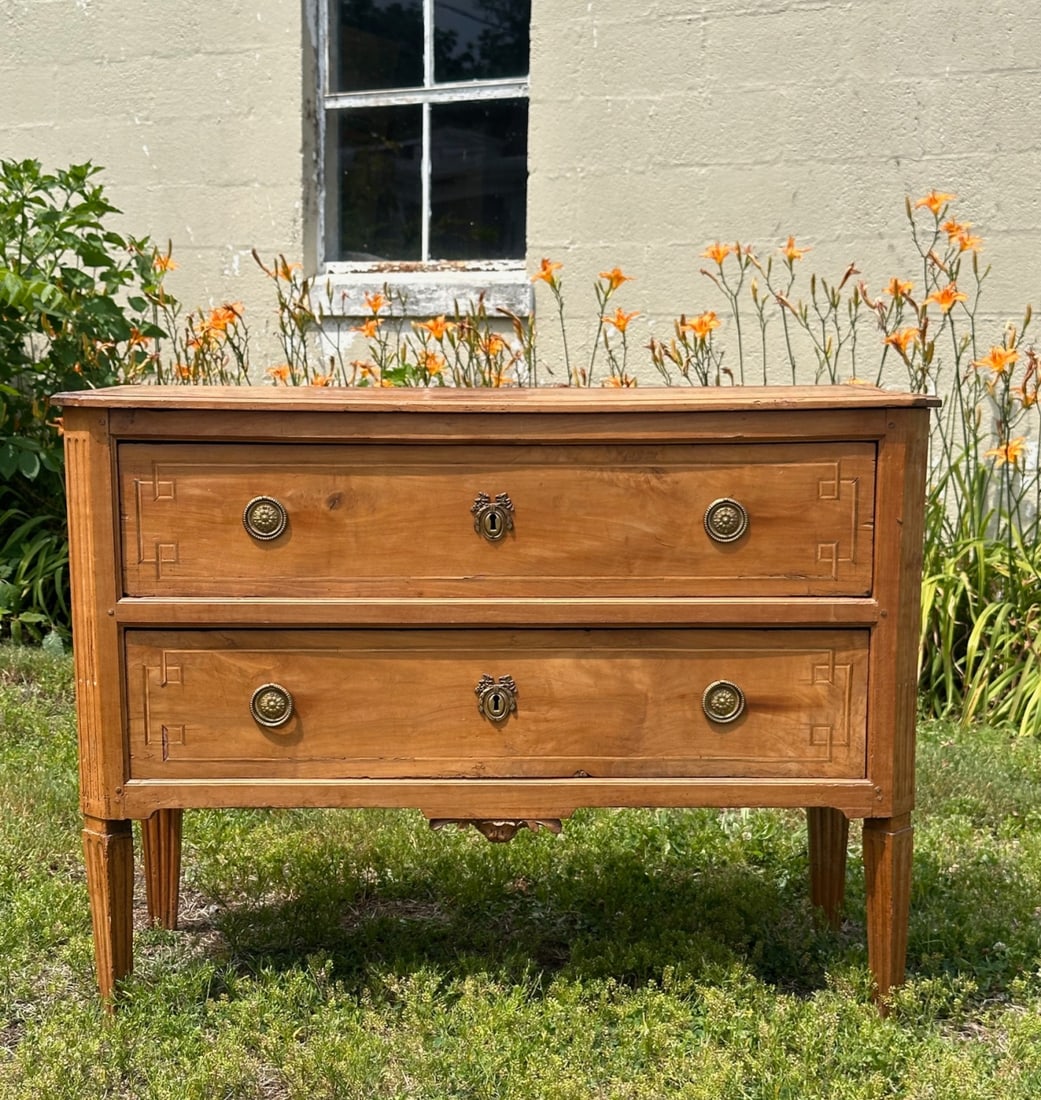 Antique Continental Fruitwood Inlaid Commode: Rectangular top above two long dovetailed drawers with brass pulls, shaped apron centered by shell pendant, raised on square tapered fluted legs, some minor damage and wear. Approx. 34" x 45" x 20". O