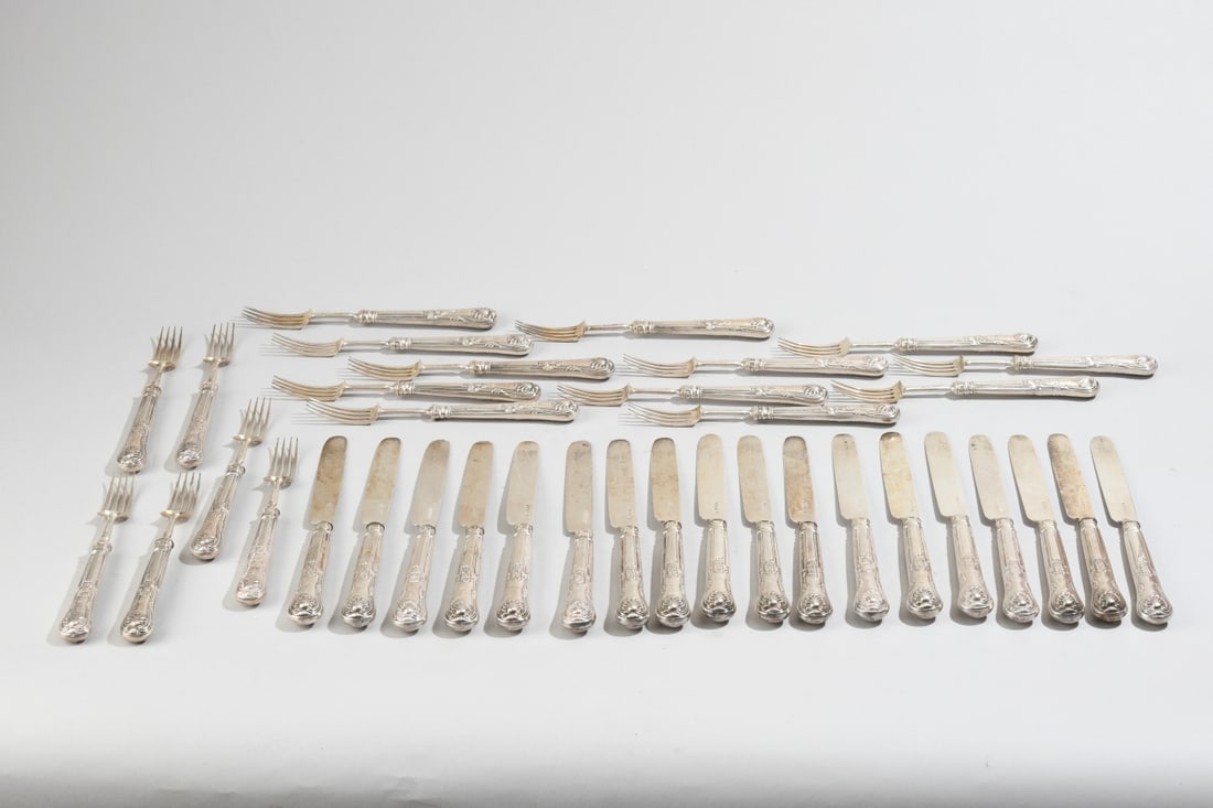 36 pcs. William IV Sterling Silver Dessert Service: An antique English sterling silver dessert or fruit flatware service comprising 18 forks and 18 matching knives. Each piece features filled sterling silver handles decorated in an embellished,