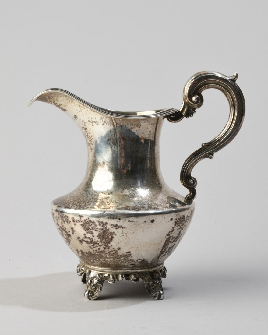 Victorian Sterling Silver Cream Jug: Maker's mark ED (London), 1844, baluster body with scroll handle, no monogram, some minor dings and dents. H: approx. 5 5/8", approx. 5 1/2" from spout to handle. Weight: approx. 7.42 ozt. Our