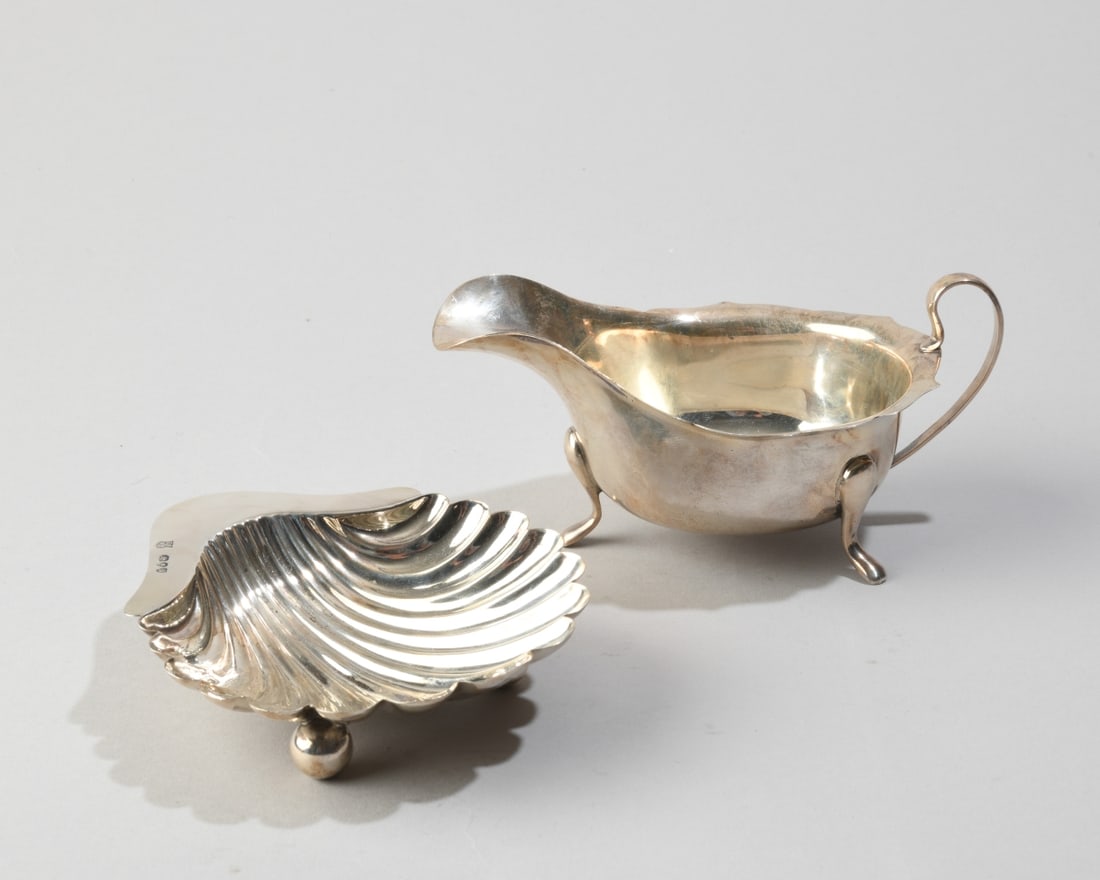 English Sterling Shell Dish & Small Sauce Boat: No monograms, sauce boat with faded maker's mark (E?, Sheffield) and "Buckingshire" to underside and dated 1950, the shell dish with maker's mark E.F over H.T (London) and dated 1891. Total weight: ap