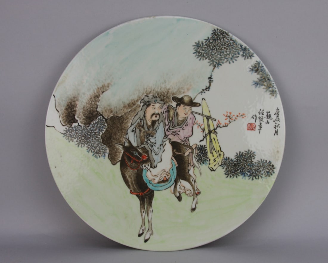 Chinese Enamel Decorated Qianjiang Style Plaque: Chinese Enamel Decorated Qianjiang style porcelain round plaque. Depicting a scholar and a boy on a horse.Calligraphy and red seal at right. 13 3/4" diameter. Our primary recommendation is to arrange