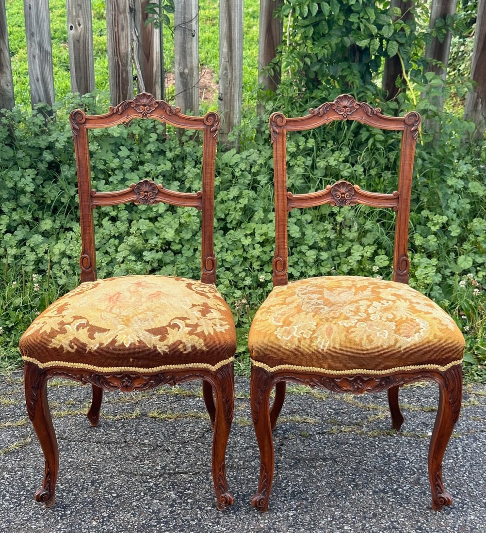 Pair Louis XV Style Upholstered Side Chairs: 20th century, with shaped crestrail featuring shell motif, serpentine upholstered seats, floral and foliate decoration to apron, cabriole legs with scroll feet. H: approx. 35". W: approx. 18 1/2". D: