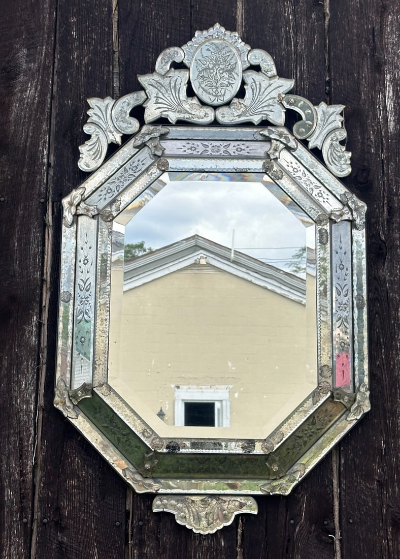 20th C. Venetian Etched Glass Mirror: With beveled central mirror plate, applied mirrored glass frame, pierced scrolled crest, foliate and floral etched decoration, cut and shaped mirrored glass ornaments, and applied glass flower-head