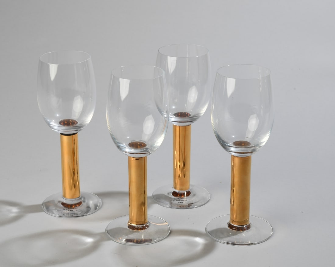 Four Orrefors Gunnar Cyren Nobel Wine Glasses: Designed by Gunnar Cyren in 1991 for the 90th anniversary of the Nobel Prize. Made of crystal with hand painted details in 21k gold, maker's mark to underside. Dimensions approx. 7 1/4" x 2 3/4". Our