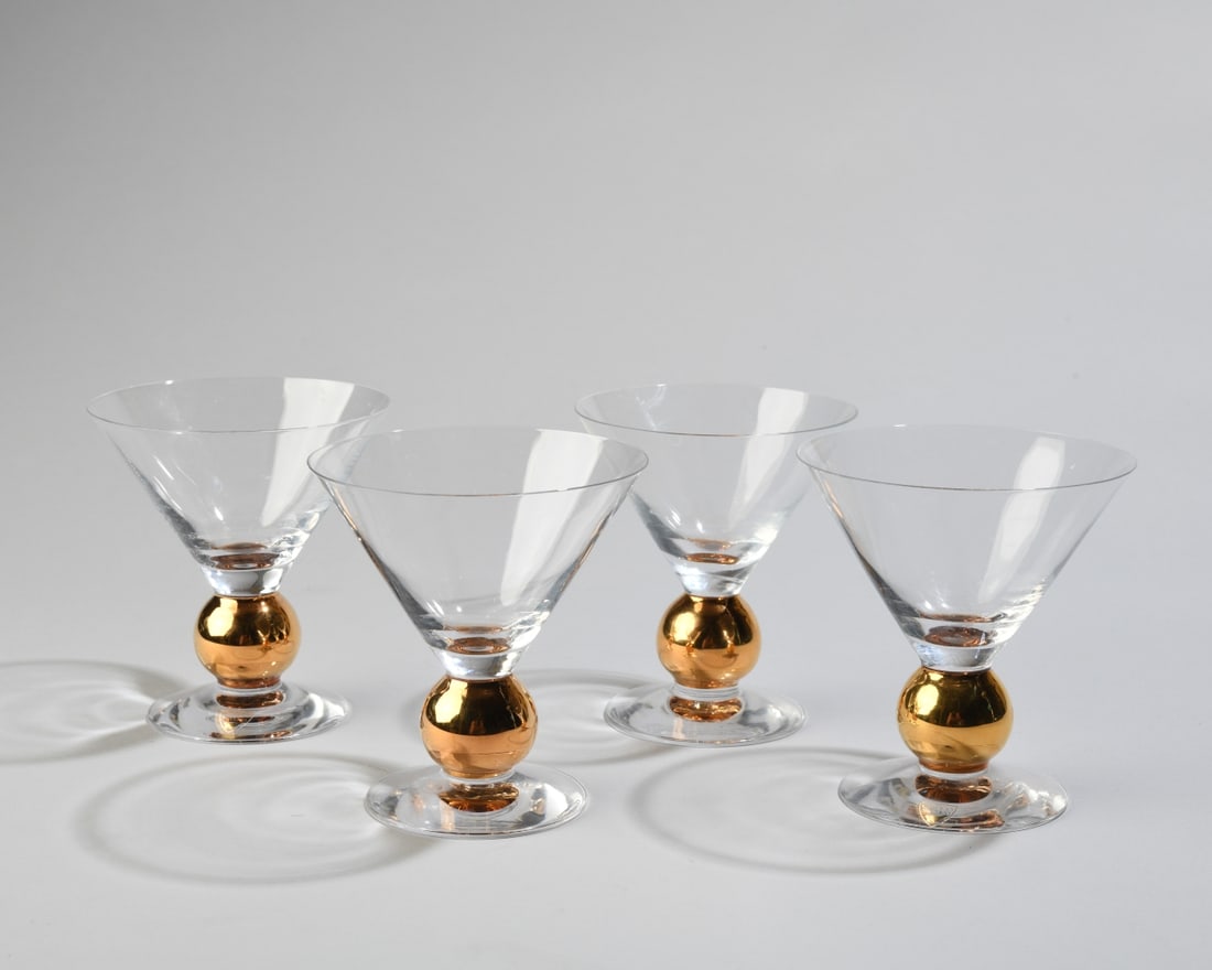 Four Orrefors Gunnar Cyren Nobel Martini Glasses: Designed by Gunnar Cyren in 1991 for the 90th anniversary of the Nobel Prize. Made of crystal with hand painted details in 21k gold, two with maker's mark label. Dimensions approx. 4 3/4" x 4". Our