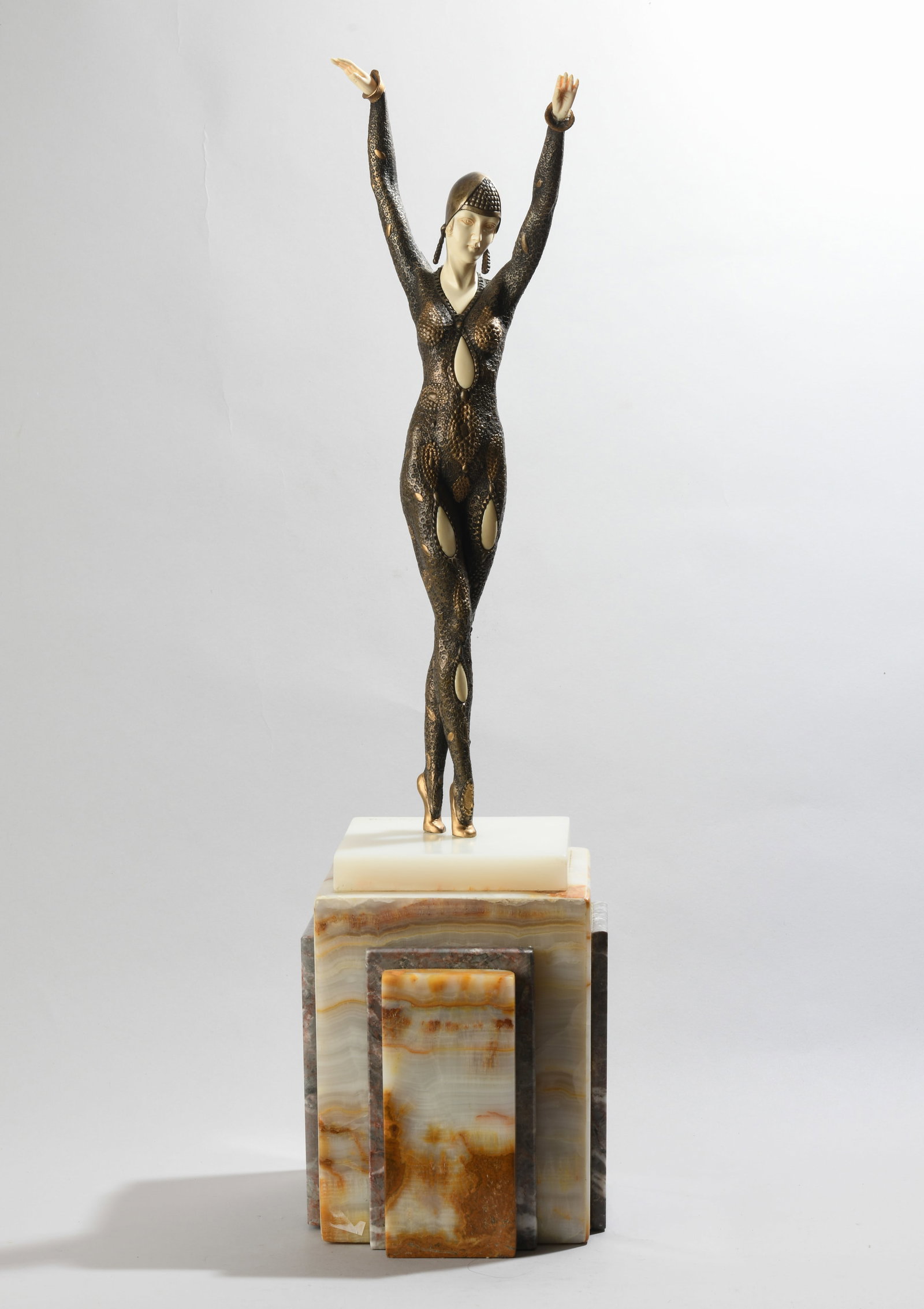After Demetre Chiparus (1886-1947) Art Deco Dancer: Bronze figure of standing dancer on stepped onyx plinth, arms raised overhead, wearing a patterned bodysuit and snood cap, incised signature "D.H. Chiparus" to top of base, "ETLING PARIS" foundry disc