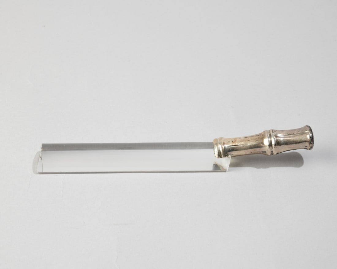 Tiffany & Co. Sterling & Crystal Page Magnifier: Elongated optical crystal reading bar, fitted with a bamboo form sterling silver handle, marked Tiffany & Co. Sterling. L: approx. 7 1/4". W: approx. 1". Our primary recommendation is to arrange