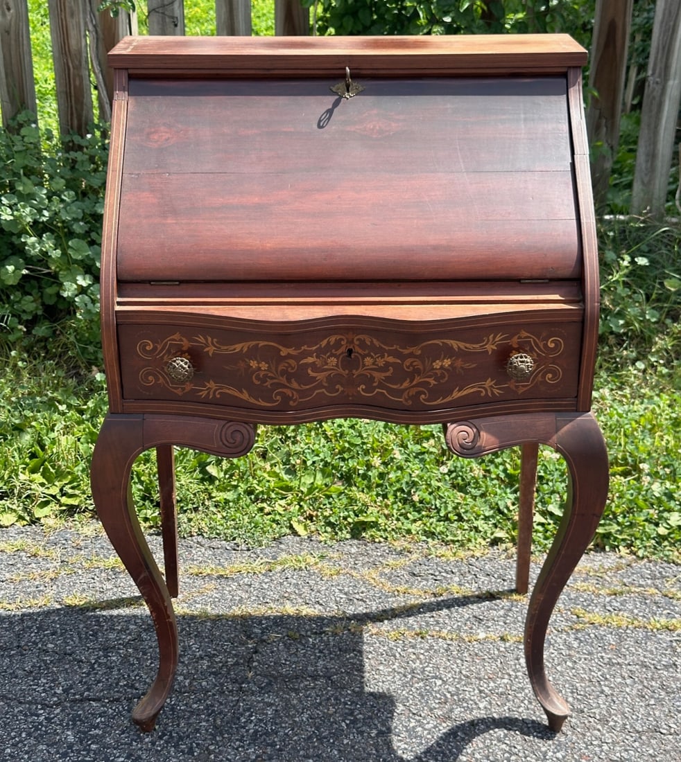 Inlaid Mahogany Slant Front Writing Desk: Curved cylinder front opening to a fitted interior with green writing surface, pigeonholes, and small drawers, on cabriole legs with pad feet. Some abrasions and scuffs. H: approx. 40". W: approx. 27.
