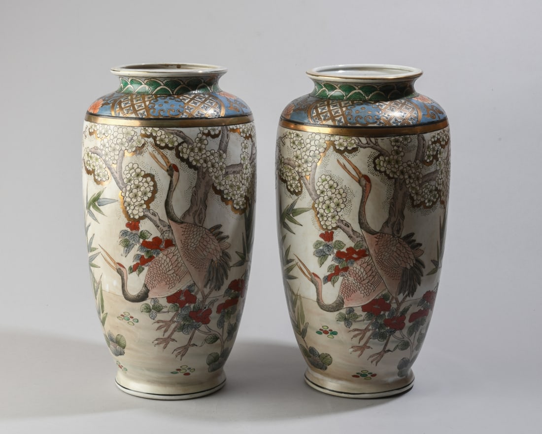 Pair of Japanese Satsuma Style Porcelain Vases: 20th century, decorated with cranes amid flowering cherry branches, each with red triangular mark to underside. Light wear and rubbing, no visible chips, cracks or repairs. Dimensions approx. 14" H x 