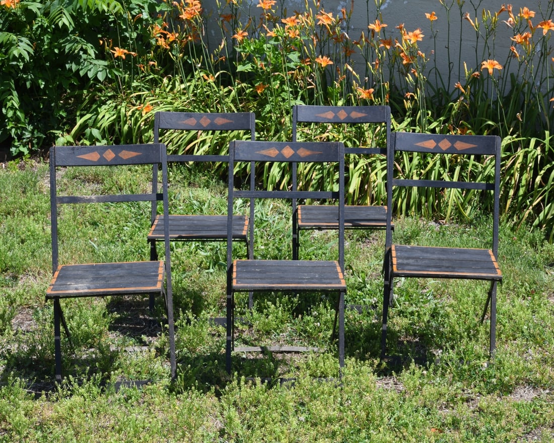 A Set of Five Folding Bistro Chairs: A matching set of five antique, French style folding bistro chairs, featuring hand painted ochre accents on the backrests and seat borders. Underside of the metal seat slat stamped "C E Z." Open dimen