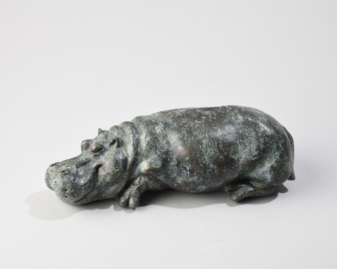 Rosalie Johnson (British, b. 1933) Hippopotamus: A finely detailed, limited-edition cold-cast bronze resin sculpture of a recumbent hippopotamus by highly regarded British wildlife artist Rosalie Johnson. Signed and number 146/150. Dimensions