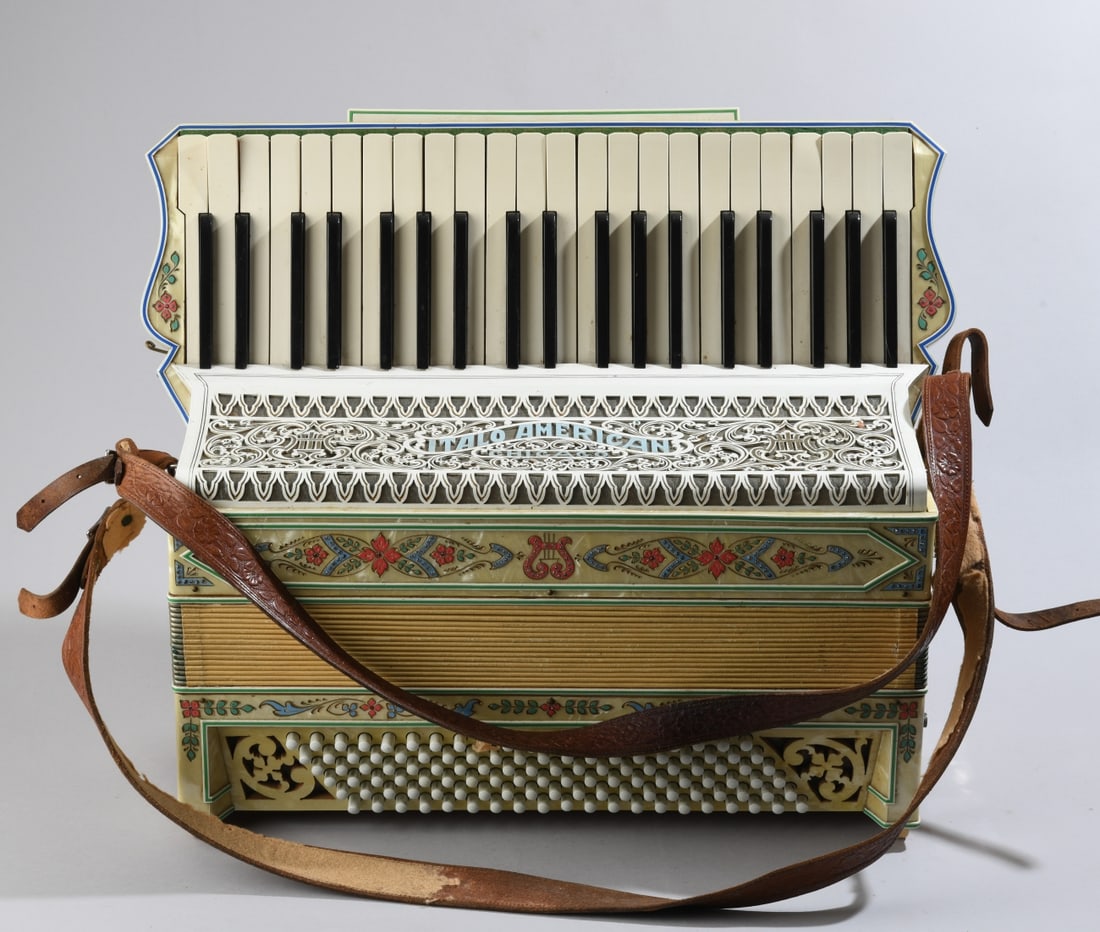 Italo-American Accordion Co. Accordion: Pearloid clad accordion with painted floral decoration, carrying case, and leather straps. Branded "Italo-American Accordion Co., Chicago" and "Made by Italo-American, Chicago." Appears to play, one