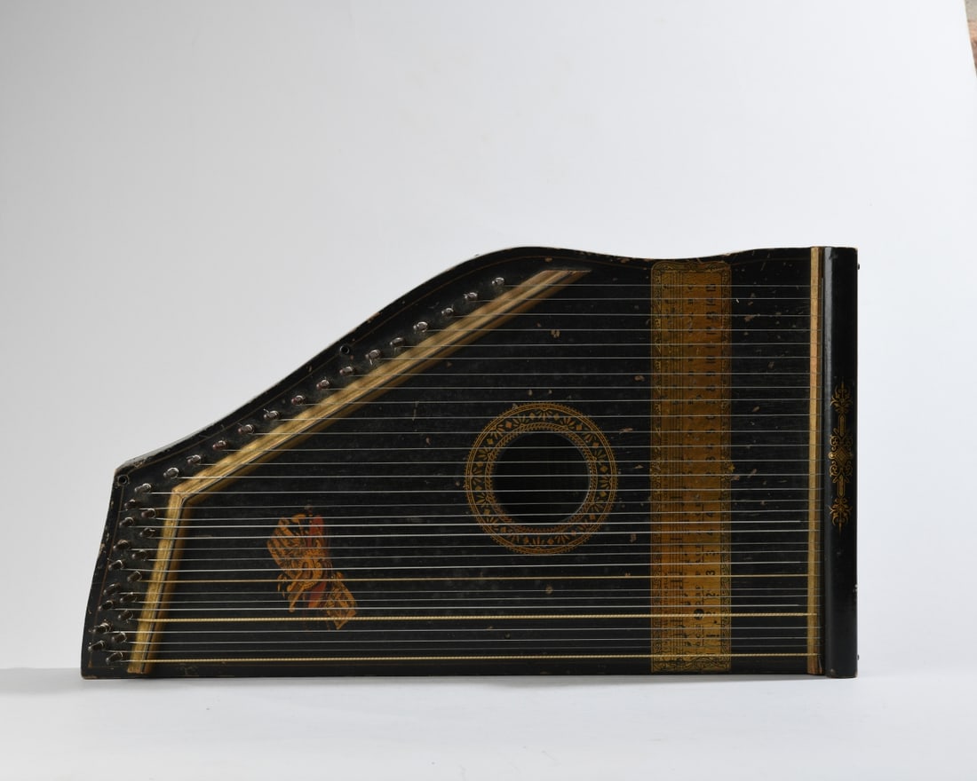 H. S. Nace Mfg. Co. "Hawaiian Harp" Zither: Late 19th / early 20th century, black-painted wooden Hawaiian harp (zither) with gilt decorative borders, printed chord and note guide, and maker's label visible through soundhole reading "Hawaiian