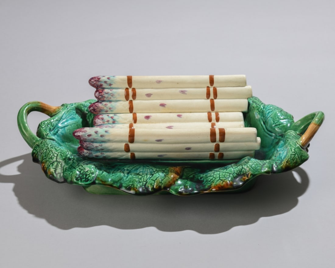 Antique French Majolica Asparagus Dish: An antique French Majolica asparagus serving platter. Features a central, molded bundle of white and purple-tipped asparagus stalks integrated into a deep green leaf molded base with twin branch
