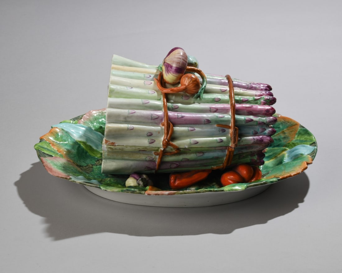 Antique French Majolica Asparagus Tureen: An antique French Majolica covered vegetable tureen. Features a sculptural lid modeled as a large bundle of white and purple asparagus stalks topped with a garlic bulb and onion. Blue hand-painted