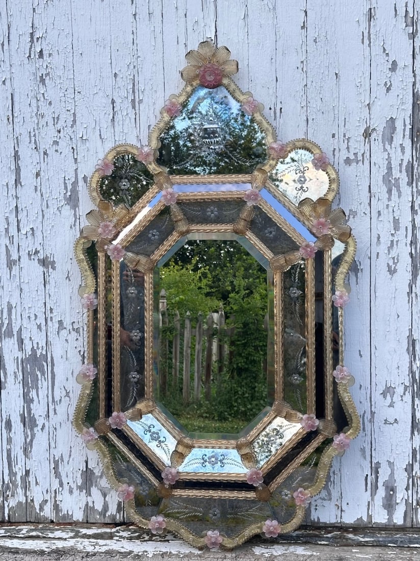 Venetian Style Glass Mirror: Ornate wall mirror with shaped crest and scalloped border, beveled central plate, etched mirrored panels with floral decoration, and applied amber and pink glass floral ornament. Approx. 54" x 30". Ou