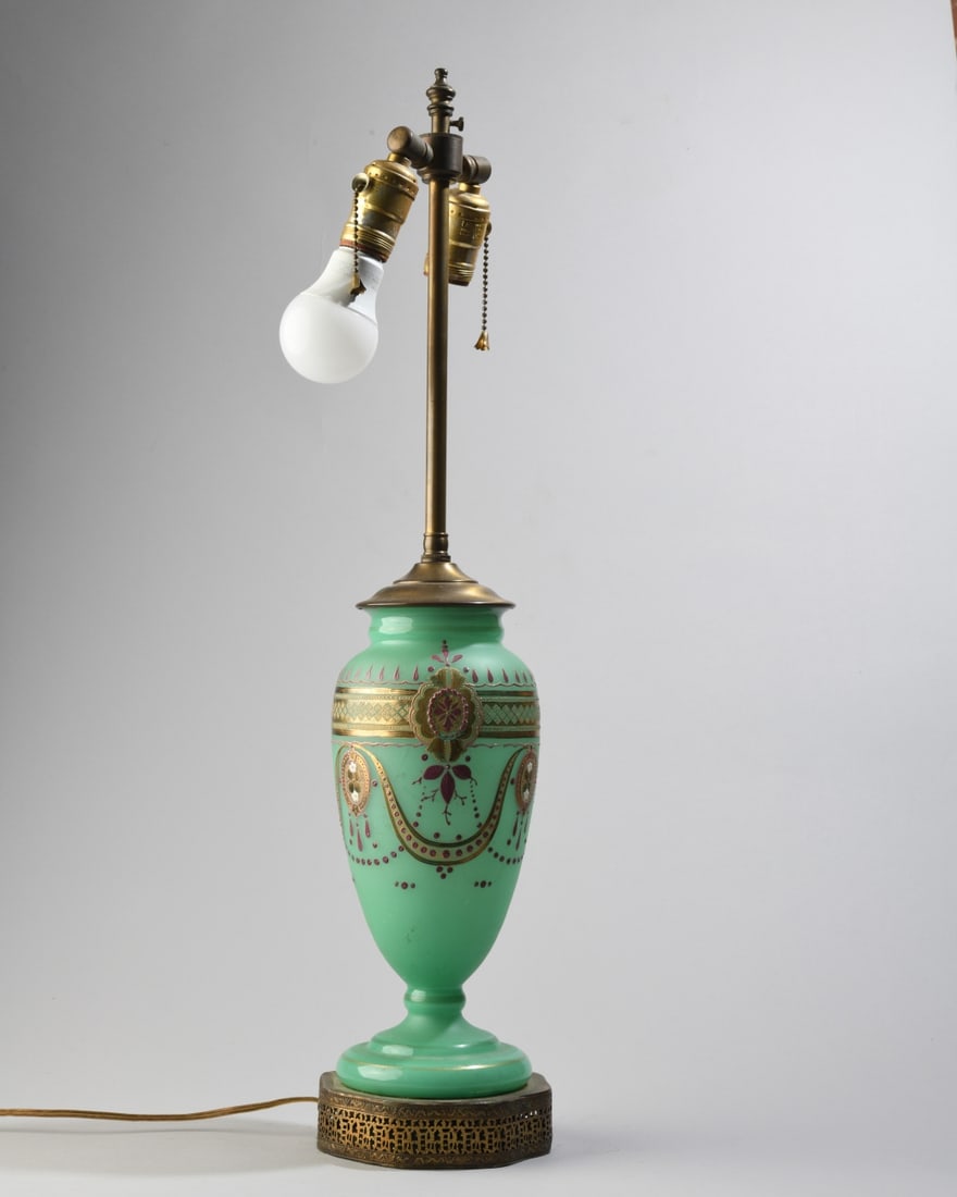 Victorian Bristol Glass Vase as Lamp: Body with hand painted Bohemian style decoration, on a pierced brass filigree base, dual cluster socket, powers on, some scratches and minor wear. H: approx. 26 1/4". Base: approx. 5 1/2" x 5 1/2".