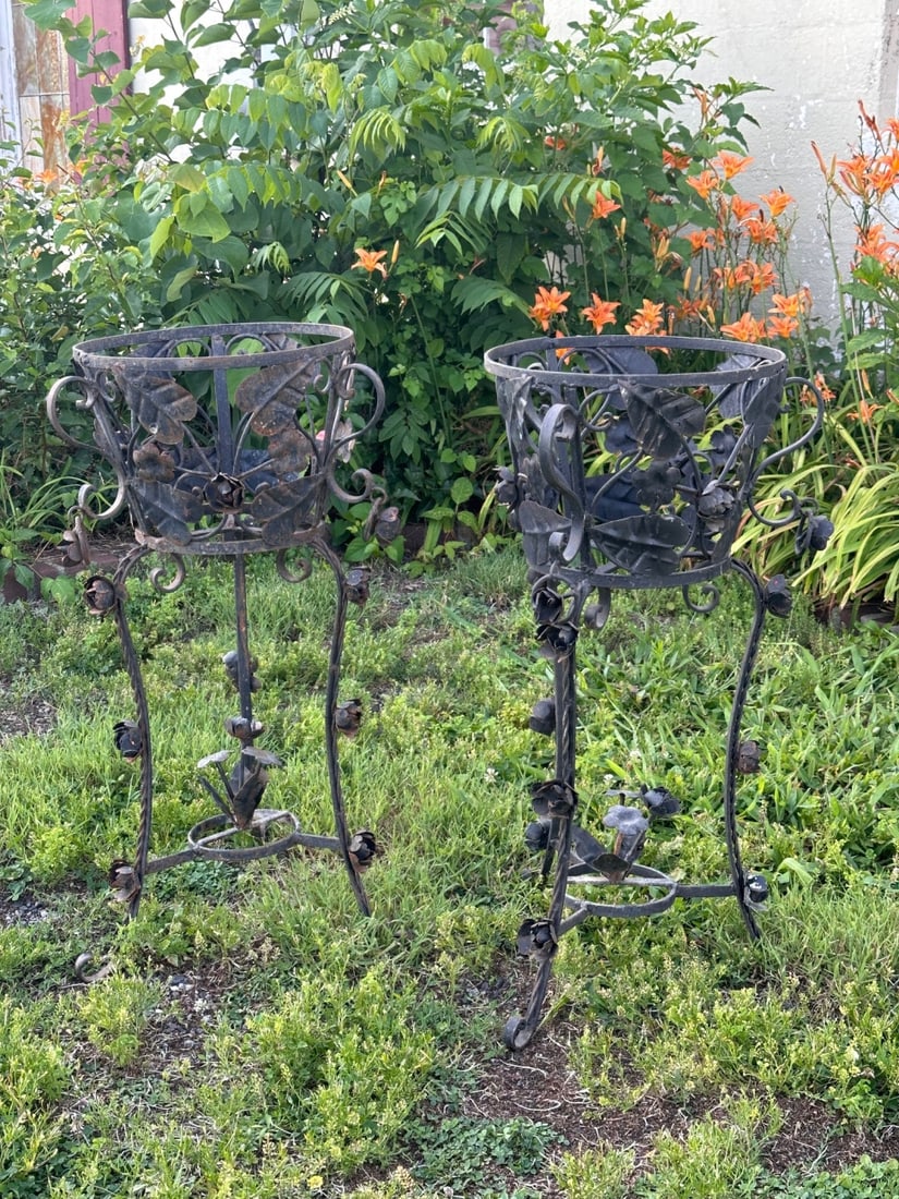 Pair of Wrought Iron Plant Stands: With floral and foliate decoration, black-painted finish (and small areas with old white and red), weathering, losses and rust. H: approx. 34", Dia: approx. 14". VHC 391 & 392 Our primary