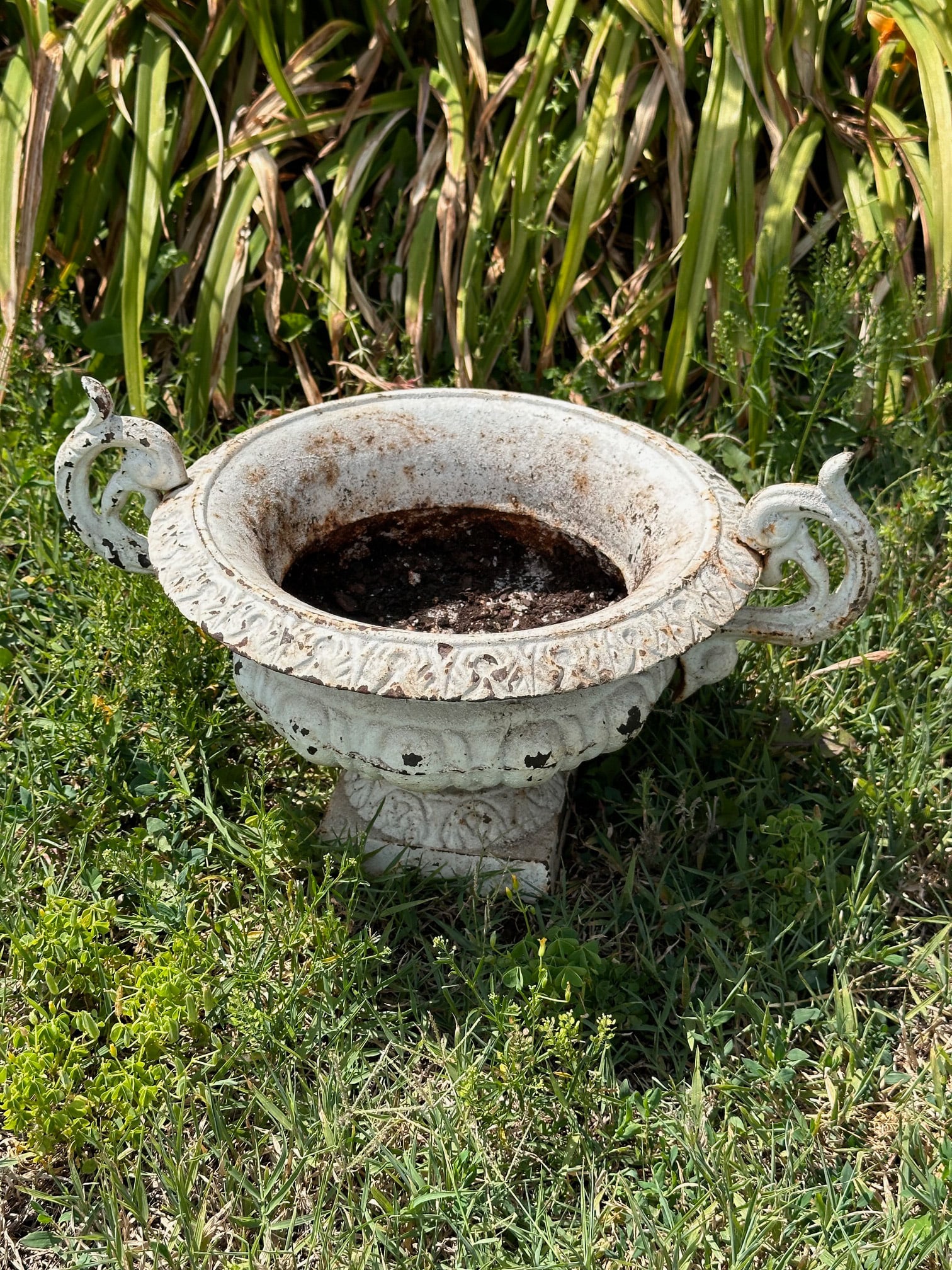 Cast Iron Garden Jardinere: White painted with scattered rust, losses and weathering. H: approx. 9 3/4", Dia: approx. 12", 16" from handle to handle. VHC 388 Our primary recommendation is to arrange shipping yourself using Blue 