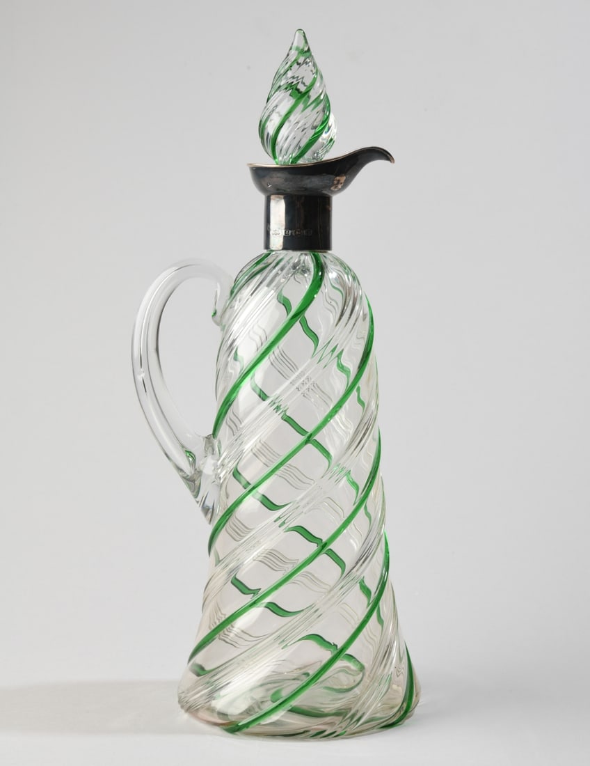 English Silver Mounted Green Swirl Glass Caret Jug: Late Victorian claret jug with silver mount marked for Elkington & Co and dated 1900. No visible chips, cracks or repairs. H: approx. 12 3/4". Base Dia: approx. 4 1/2". Our primary recommendation is