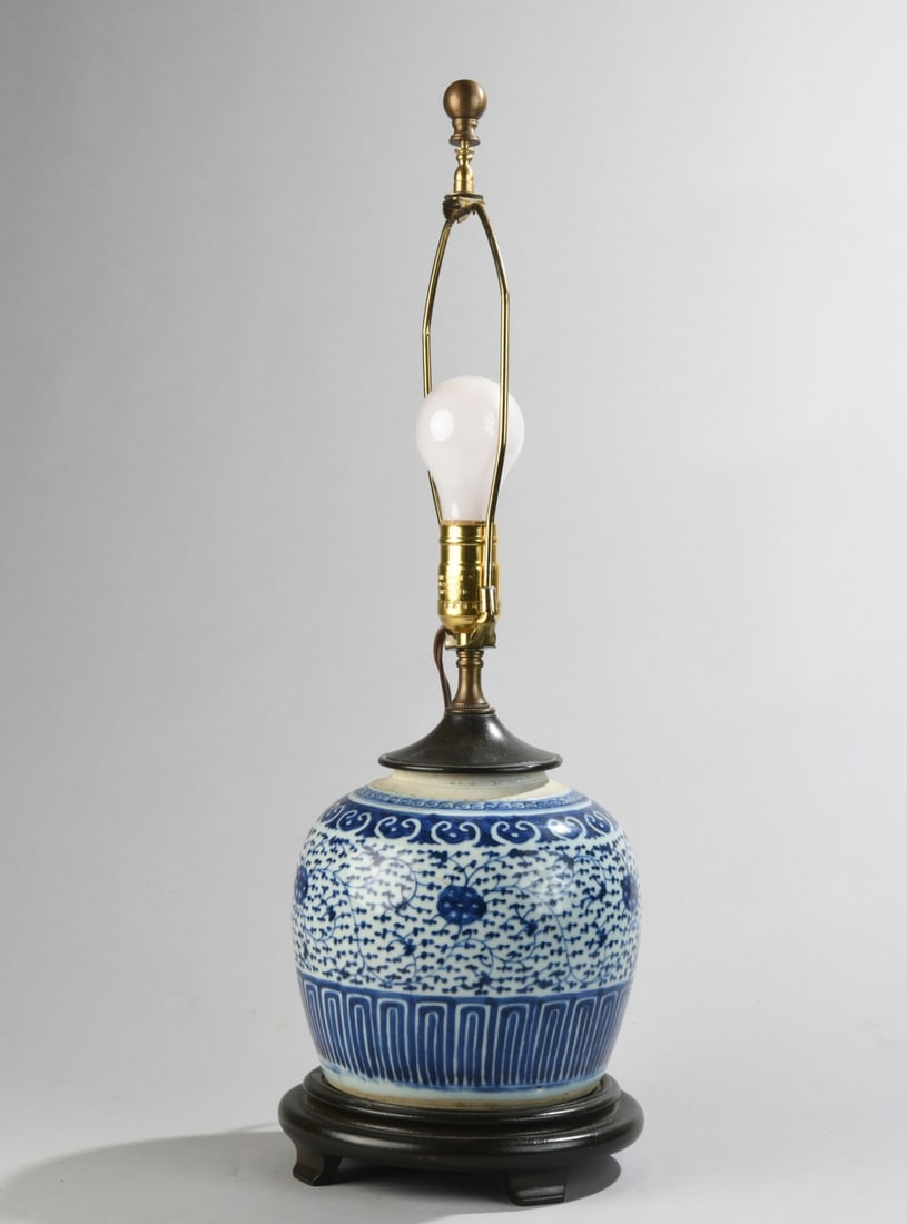 Chinese Blue & White Porcelain Lamp: Globular blue and white porcelain jar mounted as a lamp, raised on a carved hardwood stand. H: approx. 25". W: approx. 8". D: approx. 8". Our primary recommendation is to arrange shipping yourself