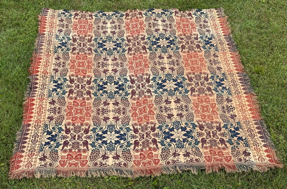 19th C. American Jacquard Coverlet: Jacquard coverlet in navy, burgundy, and tomato red on a natural ground, with an allover pattern of grape clusters, vines, and paired birds, bordered by a grapevine outer border. In as-found