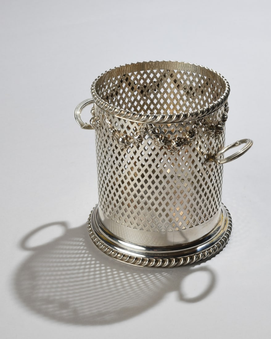 English Sterling Silver Bottle Holder: By Goldsmiths & Silversmiths Company (London), 1915, no monograms. H: approx. 5 3/4". Base Dia: approx. 5 3/8". Weight: approx. 16.13 ozt. Our primary recommendation is to arrange shipping yourself