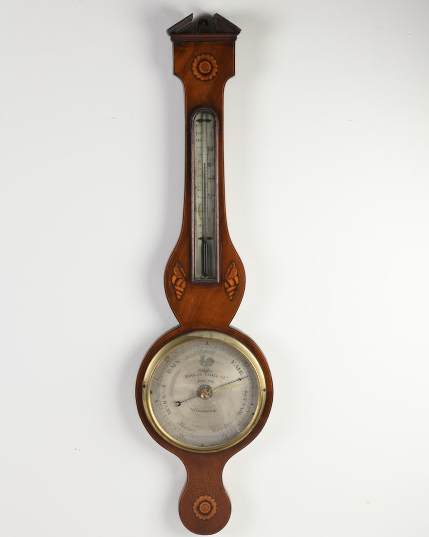 English Mahogany Wheel Barometer: Mahogany wheel barometer with floral and shell inlay. The dial signed "Francis Faveri & Co., Lincoln." Multiple breaks to glass. Dimensions approx. 38" H x 10" W x 1 1/4" D. Our primary