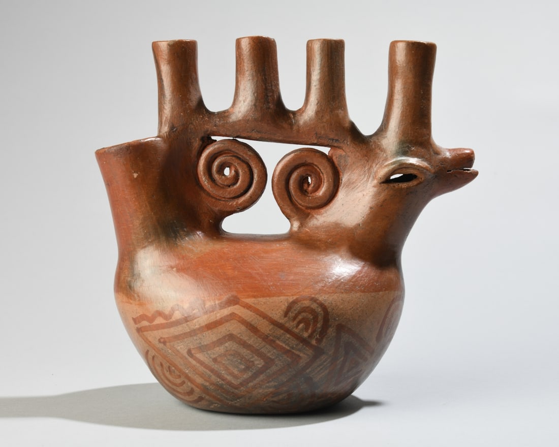 Peruvian Terracotta Zoomorphic Vessel: A 20th century Peruvian folk art terracotta vessel crafted in the Pre-Columbian Vicus style, featuring a stylized animal form with an incorporated bridge handle, open pouring spout, four vertical