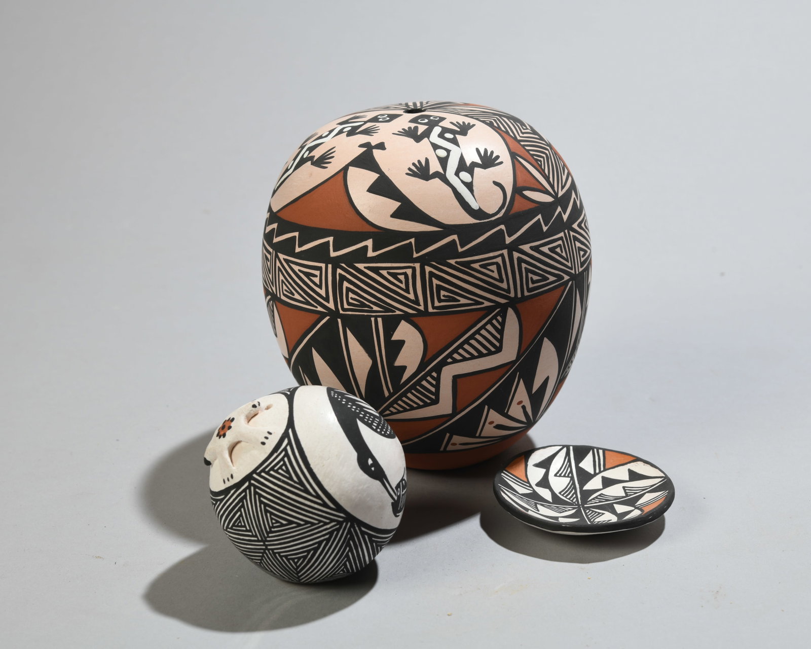Four Signed Acoma Pottery Pieces: Including seed jar signed "Caroline Lucario / Acoma, New Mexico", miniature seed jar signed "B. Aragon / Acoma, NM", and miniature dish signed "Acoma, NM / S. Phillips". No visible chips, cracks or