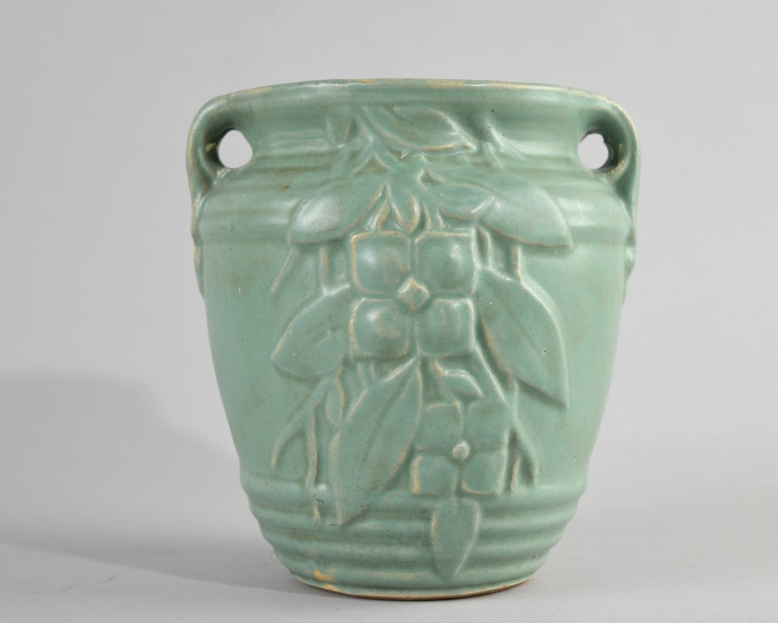 Roseville Style Double Handled Vase: Decorated in relief with floral and foliate motifs, no marks to underside. No visible chips, cracks or repairs. Dimensions approx. 6 3/4" H x 5 1/2" dia., 6 1/4" W from handle to handle. Our primary