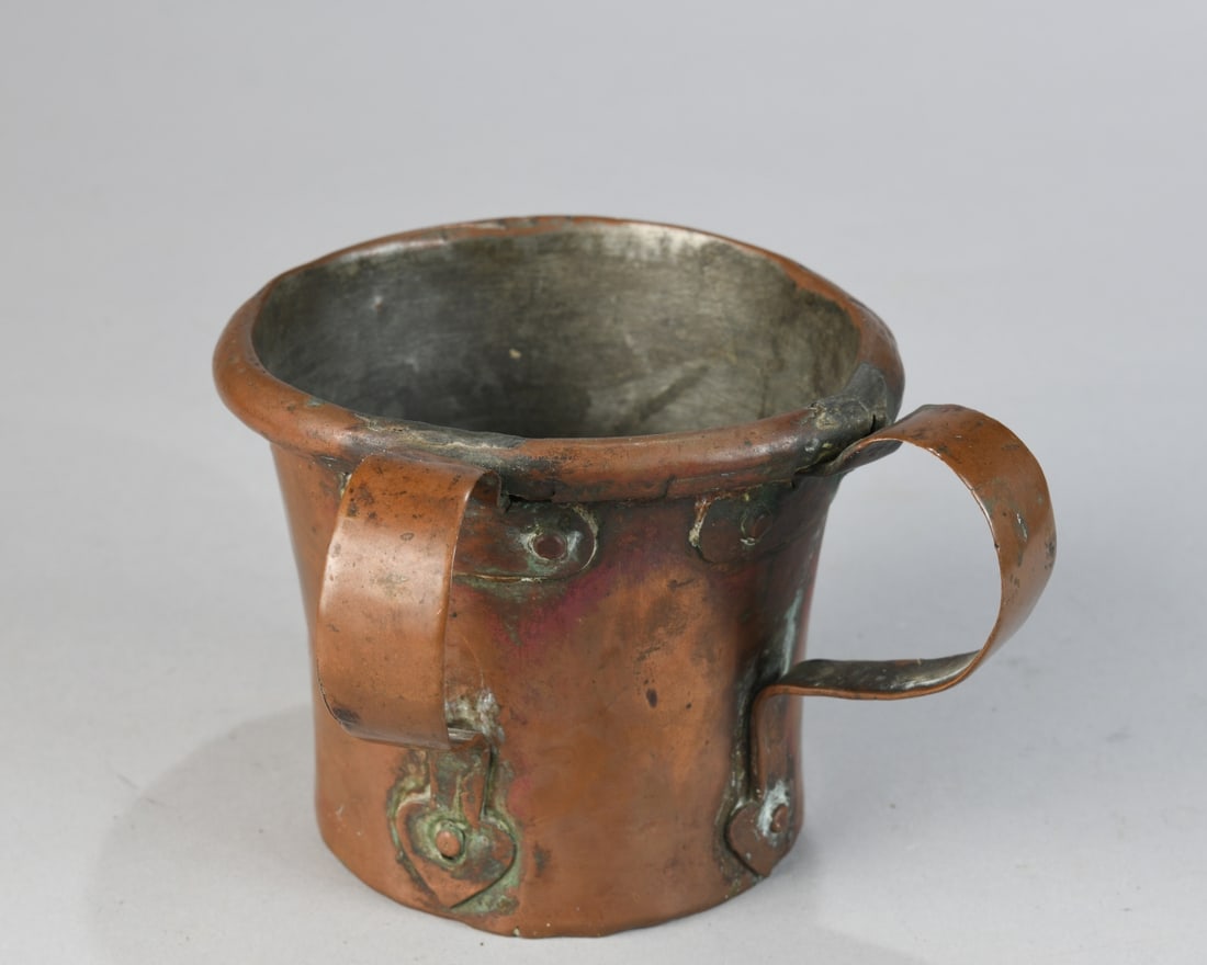19th C. Judaica, Copper Netilat Yadayim Cup: A 19th century hand-raised copper ritual hand-washing vessel (netilat yadayim cup, or natla), probably Eastern European. Of tapering cylindrical form with rolled rim, the body with punched circular or