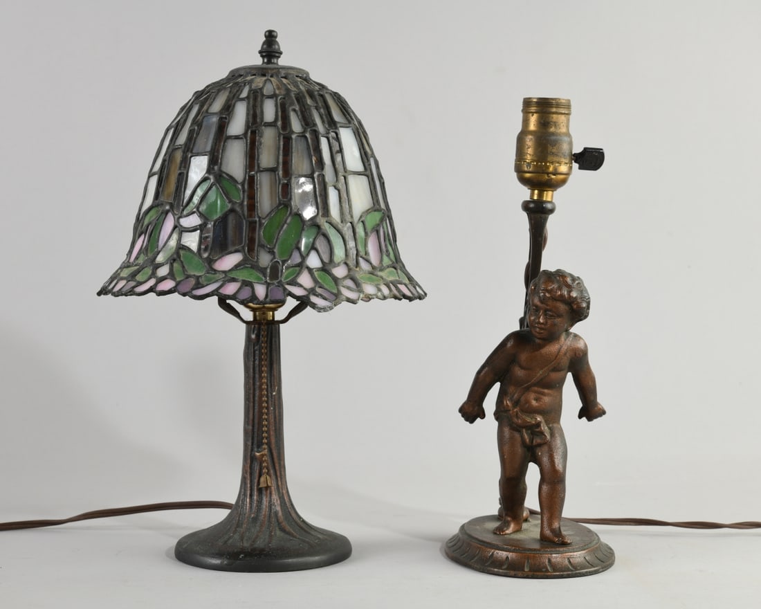 Two Vintage Metal Lamps: One with stained glass shade, the other with cherub motif and marked "Verona" to underside. Tallest dimensions approx. 13 1/2" to top of finial, dia. approx. 8 1/2". Our primary recommendation is to